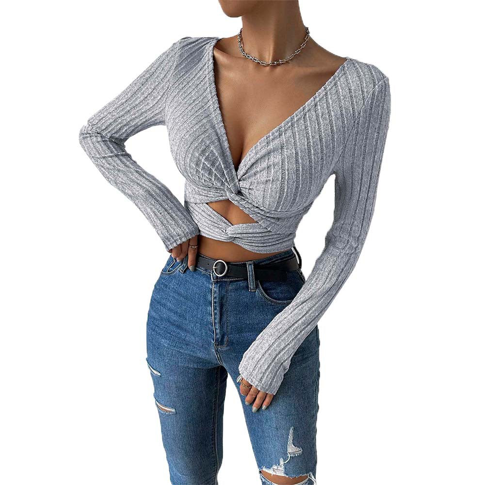 Woman wearing long sleeve crop top with V-neck and cut-out detail