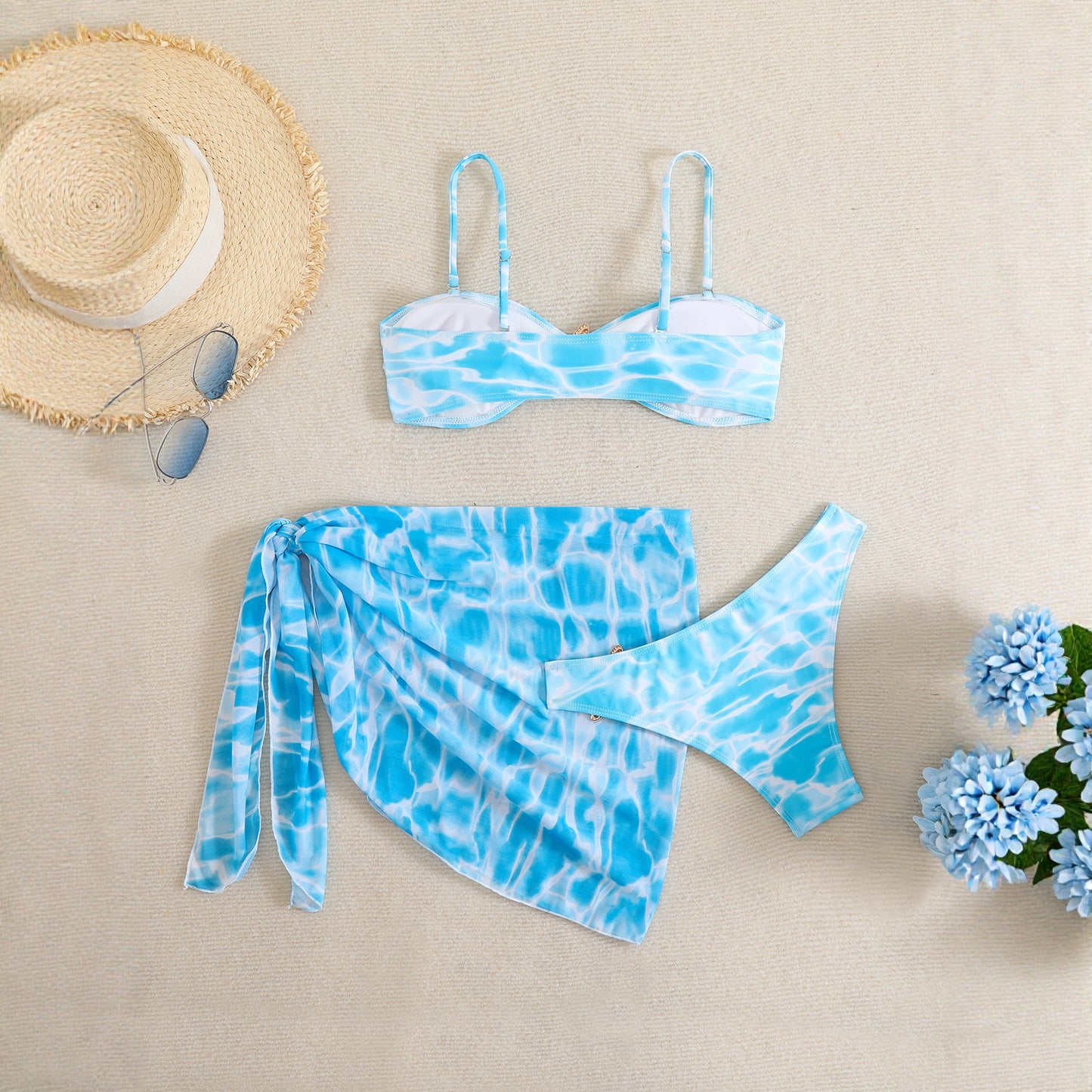 Three-piece beachwear set with water-inspired blue print