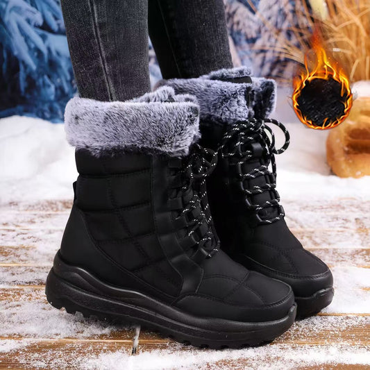 Black women's fleece-lined waterproof snow boots on snowy background