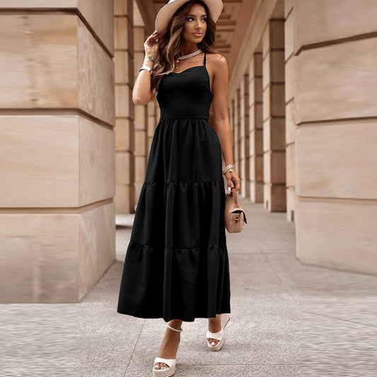 Black sling maxi dress with tiered pleated skirt, high waist and open back