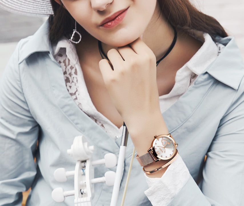 Model wearing rose gold  Olevs Heart Charm Watch with white table