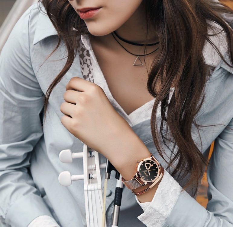 Model wearing Olevs Rose Gold Heart watch with black table and mesh bracelet