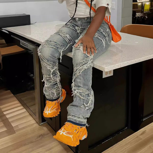 Woman wearing light blue high-waisted straight-leg jeans, standing in a relaxed pose.