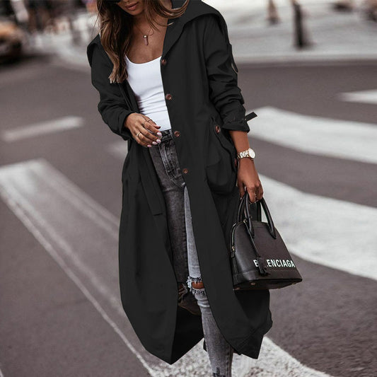 Woman wearing black long lapel trench coat with large lapel, street style