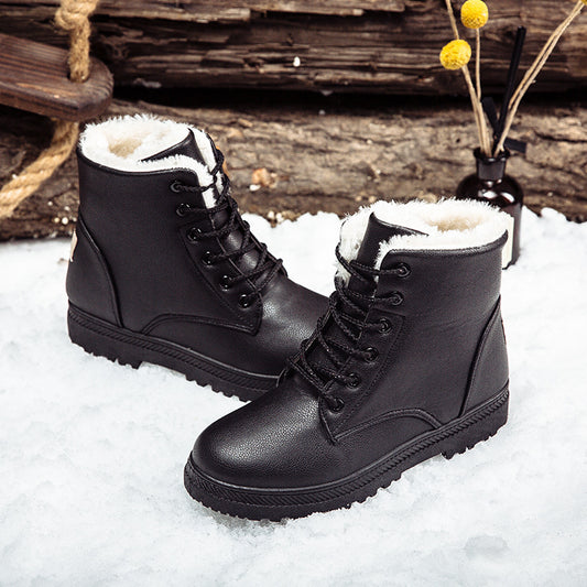 Black boots on snow background – Women’s lace-up winter boots with faux-sheepskin lining in black.