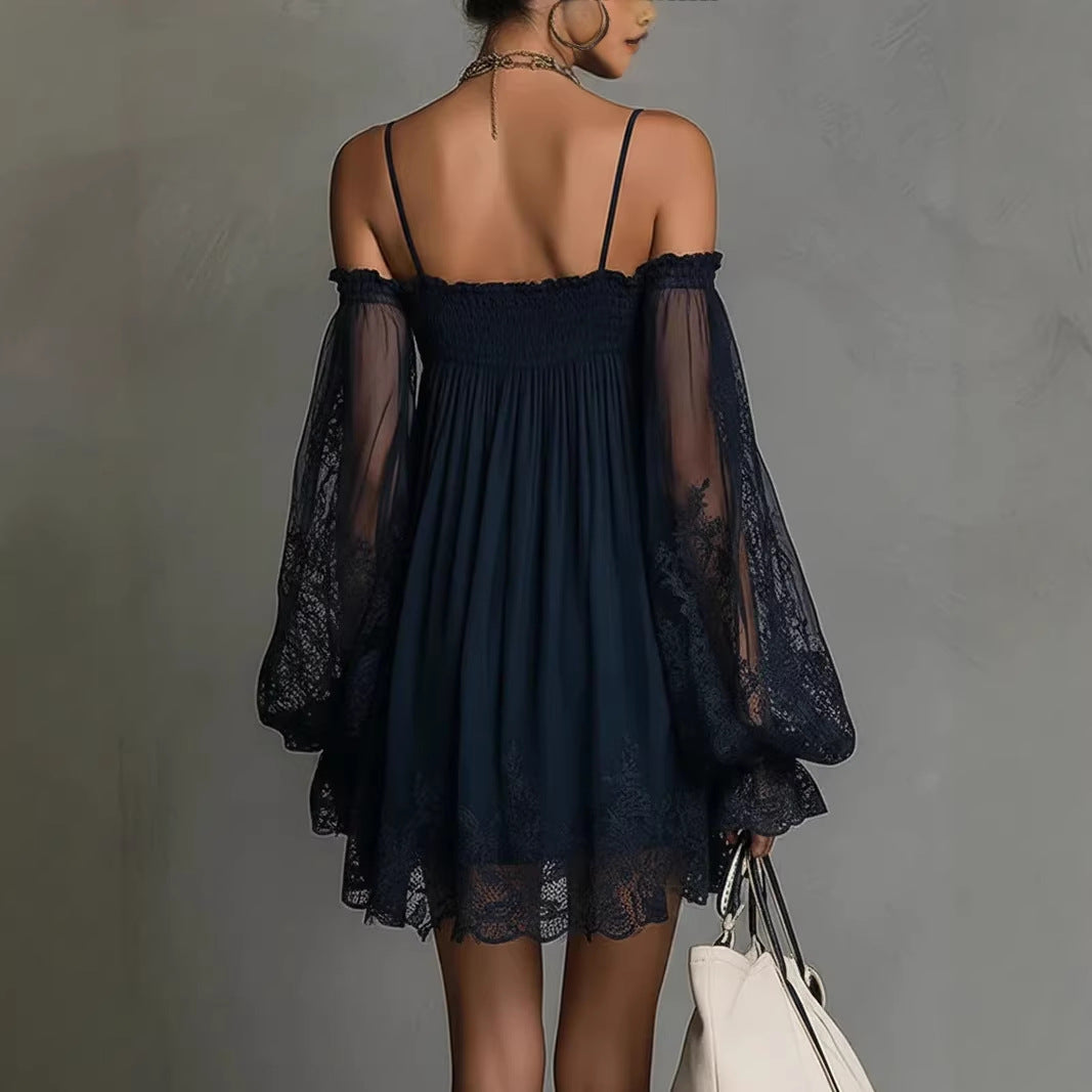 Woman wearing a dark blue flowing mini dress with lace sleeves, smocked neckline, and adjustable shoulder straps, back.