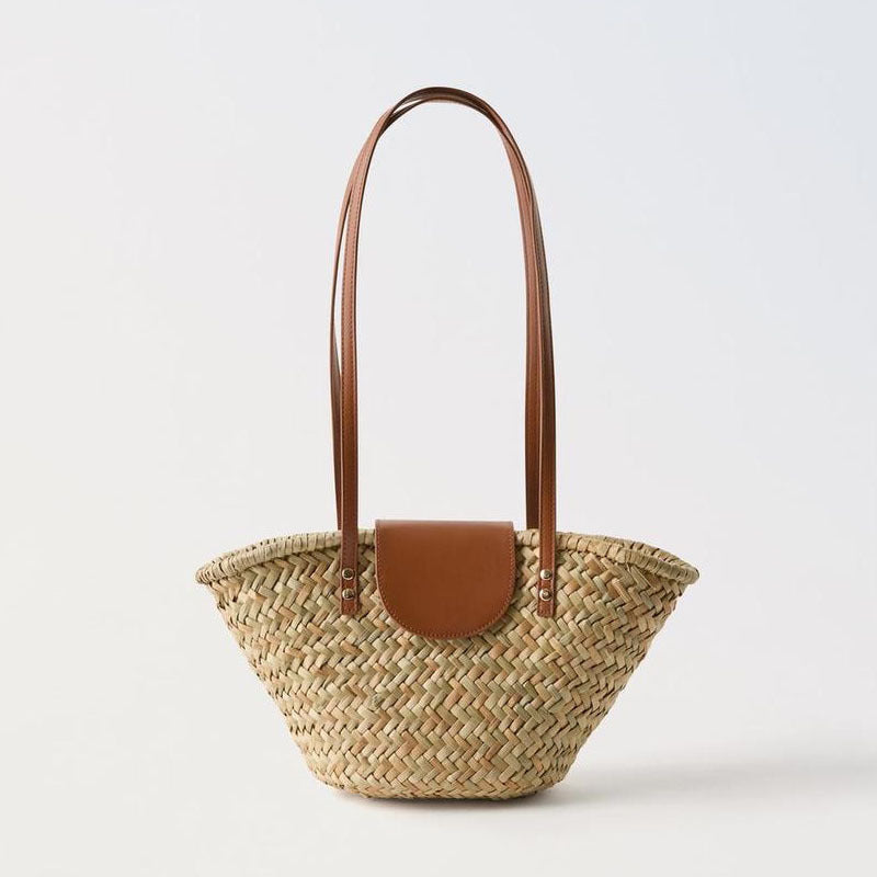 Woven straw handbag with brown faux leather flap