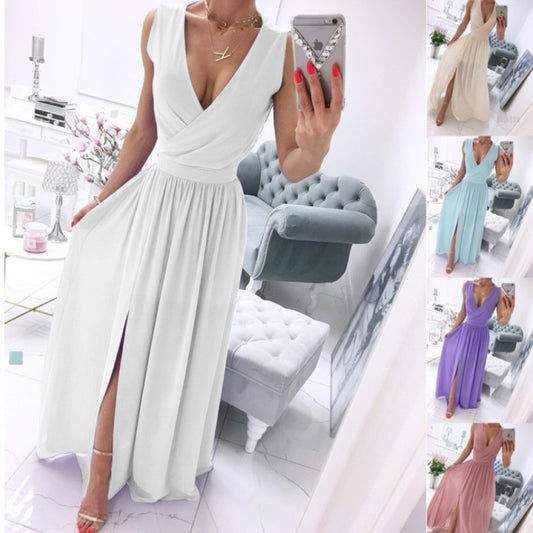 Woman wearing long white V-neck dress with front slit, taking mirror selfie in chic interior. Several color options