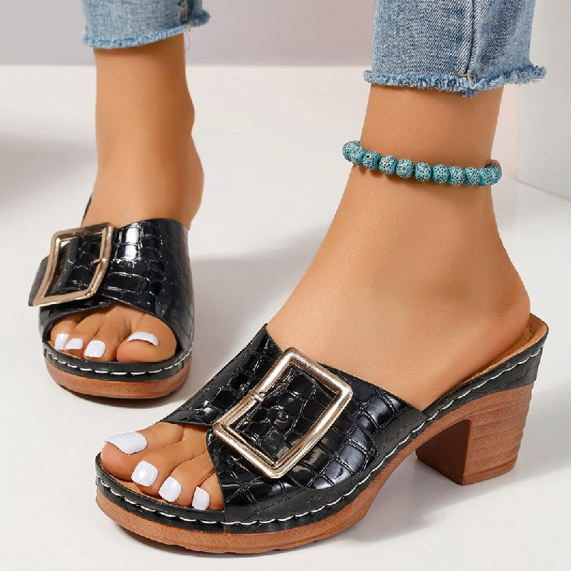 Black chunky heel peep toe sandals with crocodile texture and buckle detail.