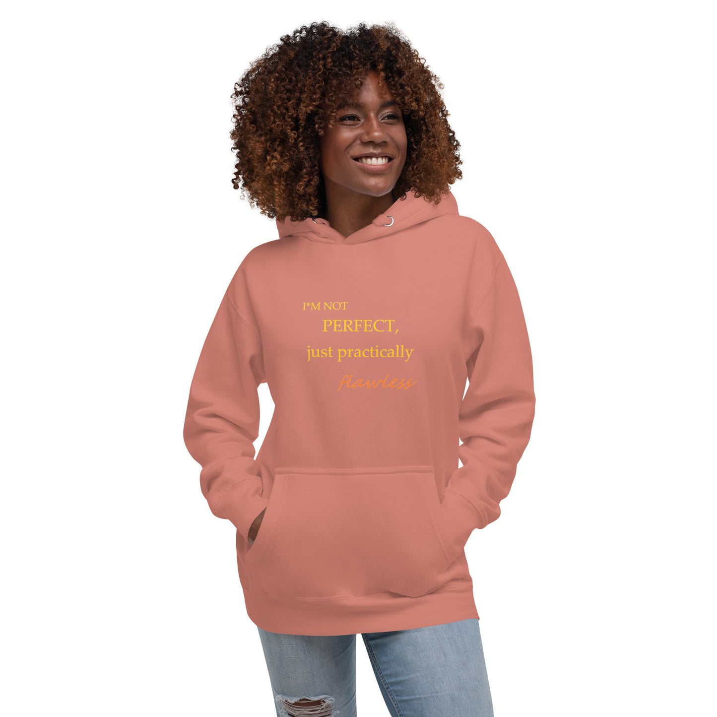 Model wearing a dusty rose unisex hoodie with "I'm not perfect, just practically flawless" design, hands in pocket, smiling.