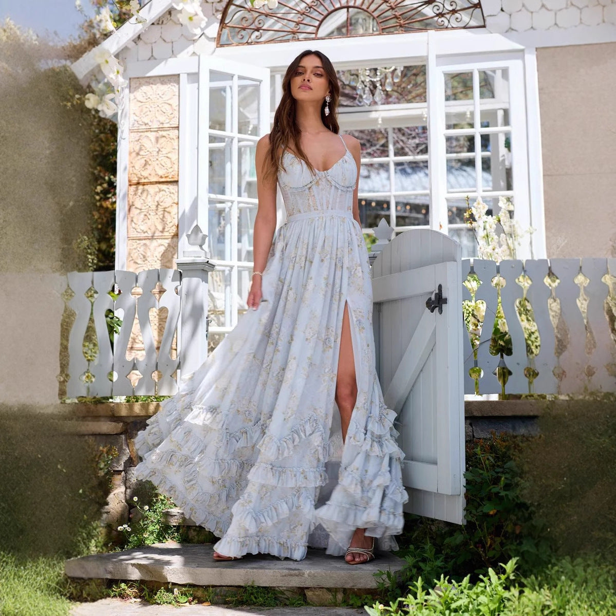 Woman in light blue floral chiffon dress with open back

