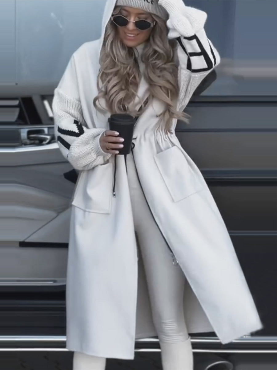 Model wearing white hooded long jacket with LOVE knit sleeves and pockets