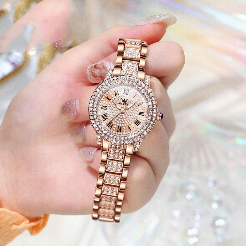 Rose gold OLEVS 9943 with diamond accents – luxury wristwatch in hand