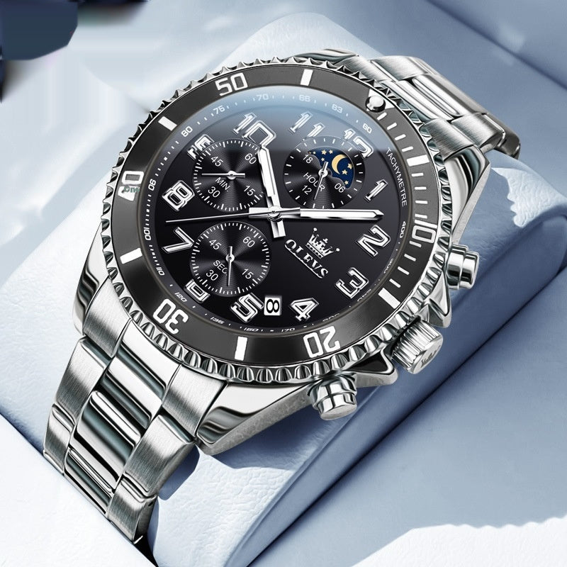 Black and silver OLEVS watch with silver markers – elegant on pillow background