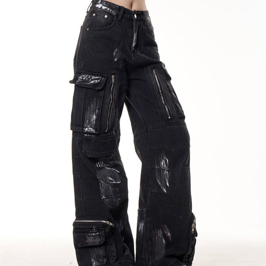 Front view of women’s graffiti-dyed wide leg cargo jeans with high waist and oversized pockets.