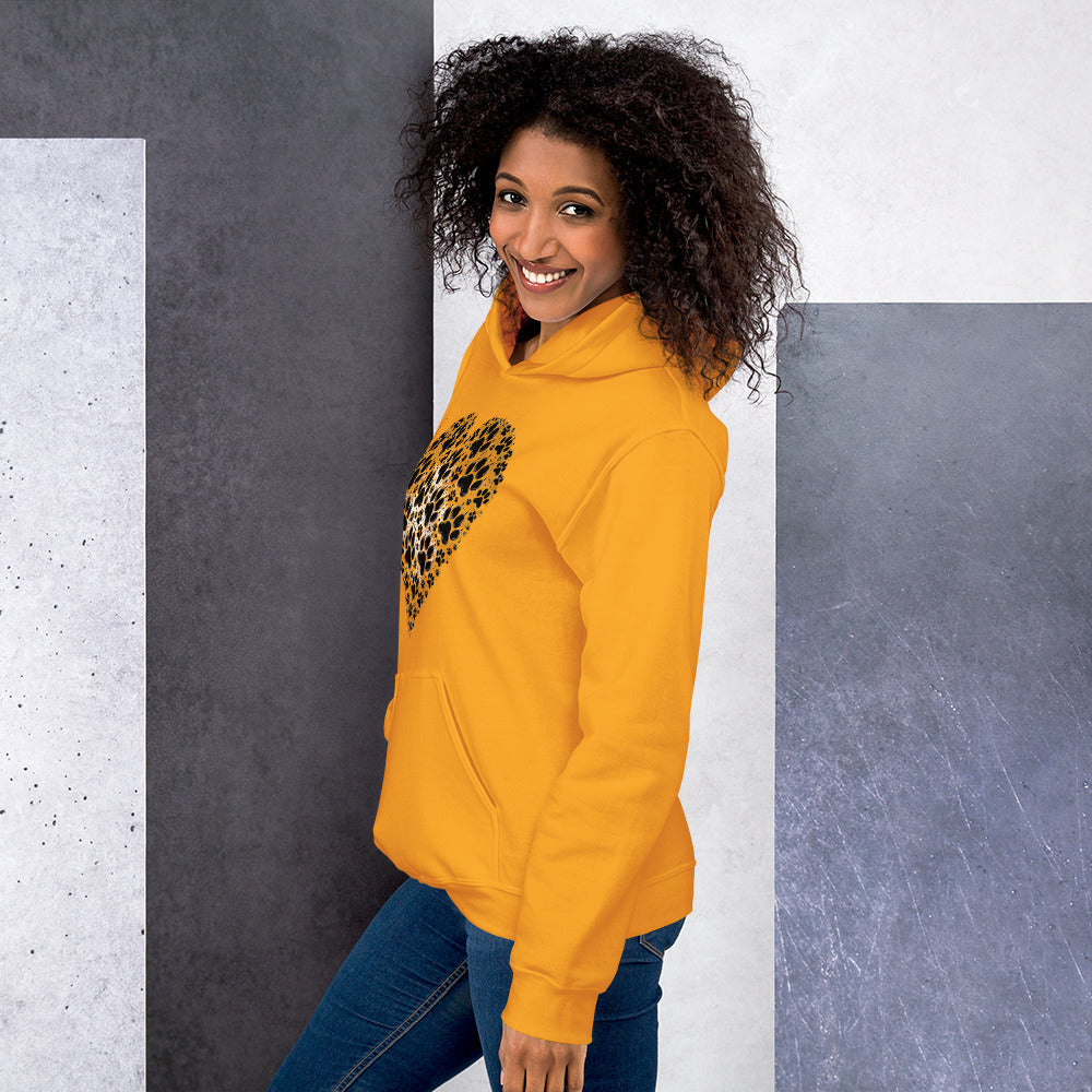 Smiling woman in profile view wearing the gold Aylure Love Paw hoodie.